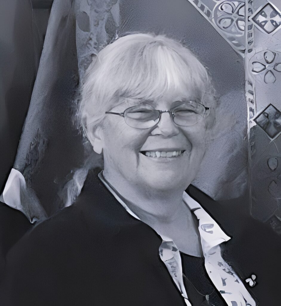 Smiling elderly woman wearing glasses and scarf