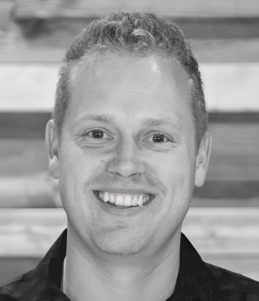 Smiling person headshot with wooden background