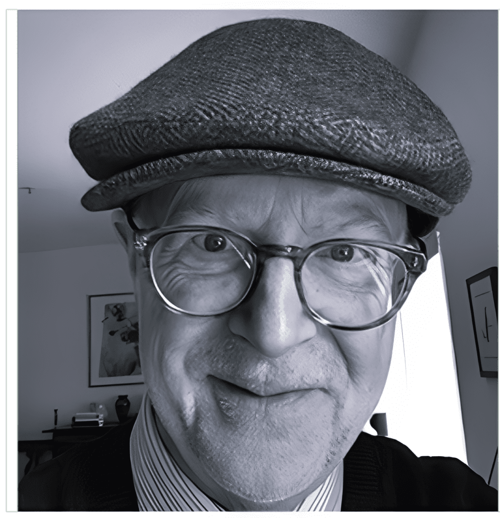 Smiling man wearing flat cap and glasses