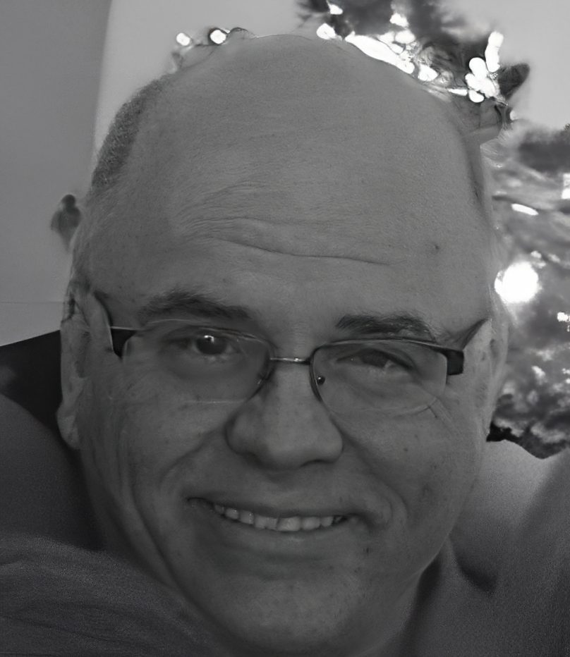 Close-up smiling bald man with glasses