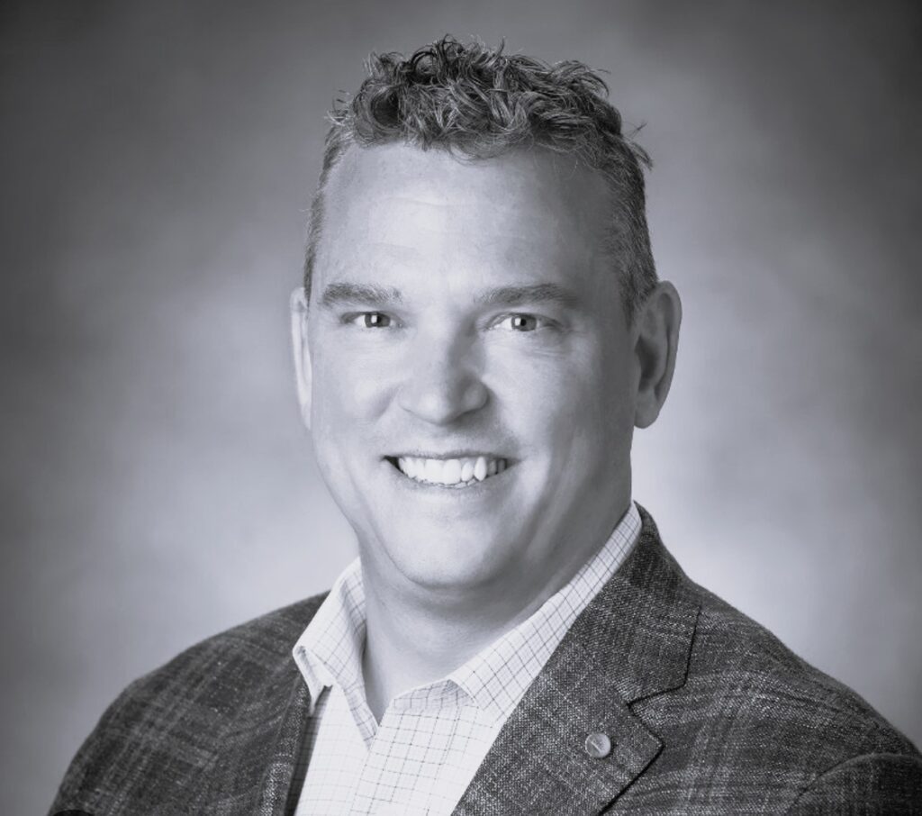 Smiling man in blazer headshot