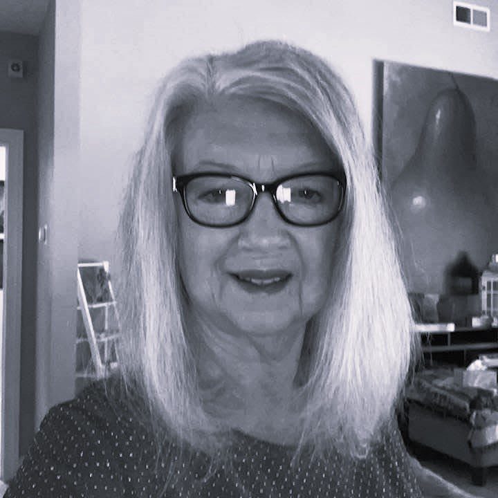 Senior woman with long hair and glasses