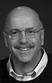 Smiling man with glasses and mustache