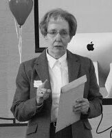 Senior lady presenting with papers