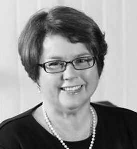 Smiling woman with glasses and necklace