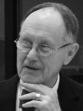 Elderly man in glasses pondering
