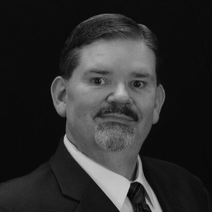 Black-and-white professional headshot of man