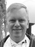 Smiling person outdoors in black and white