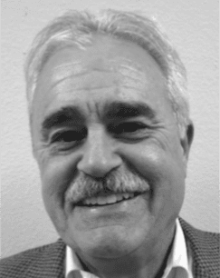 Smiling older man with gray hair and mustache