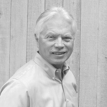 Man smiling against wooden background