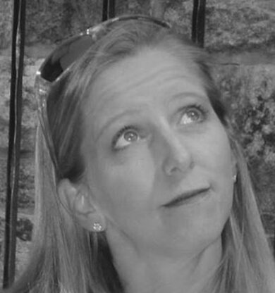 Woman with sunglasses on head, gazing up