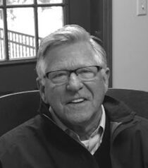 Smiling older man wearing glasses indoors