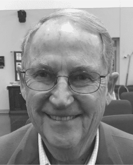 Smiling person wearing glasses indoors