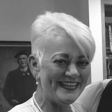 Smiling woman with short white hair