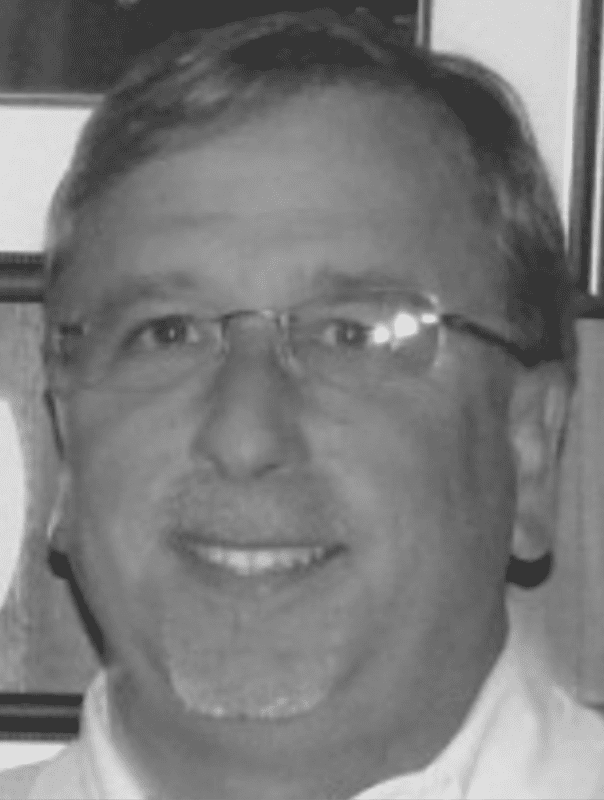 Man with glasses and goatee smiling