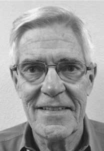 Close-up black-and-white portrait of older man with glasses