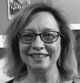 Smiling woman wearing glasses and earrings