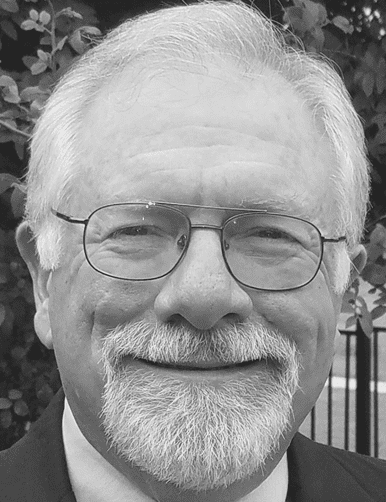 Elderly man in suit and glasses
