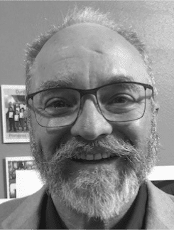 Smiling bearded man wearing glasses