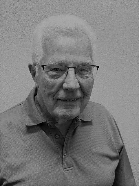 Elderly man wearing glasses and polo shirt