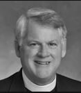 Smiling man wearing clerical collar