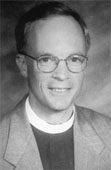 Man wearing glasses and clerical attire