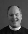 Smiling person in clerical attire