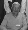 Senior wearing sweater and name tag