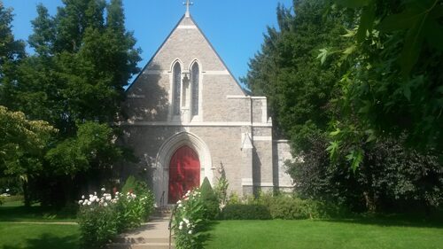 Small church in sunny garden setting
