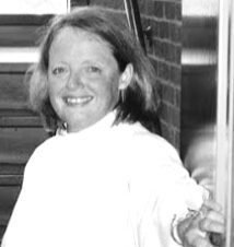 Happy woman holding a door open