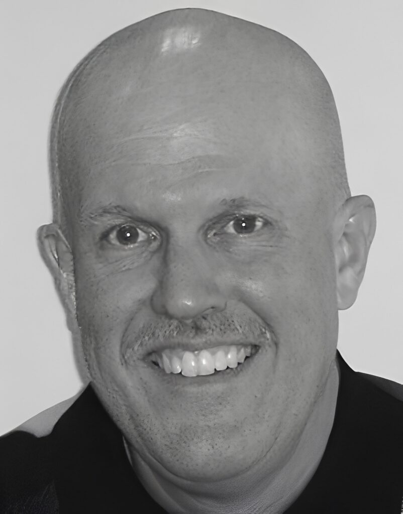 Smiling bald man with mustache close-up