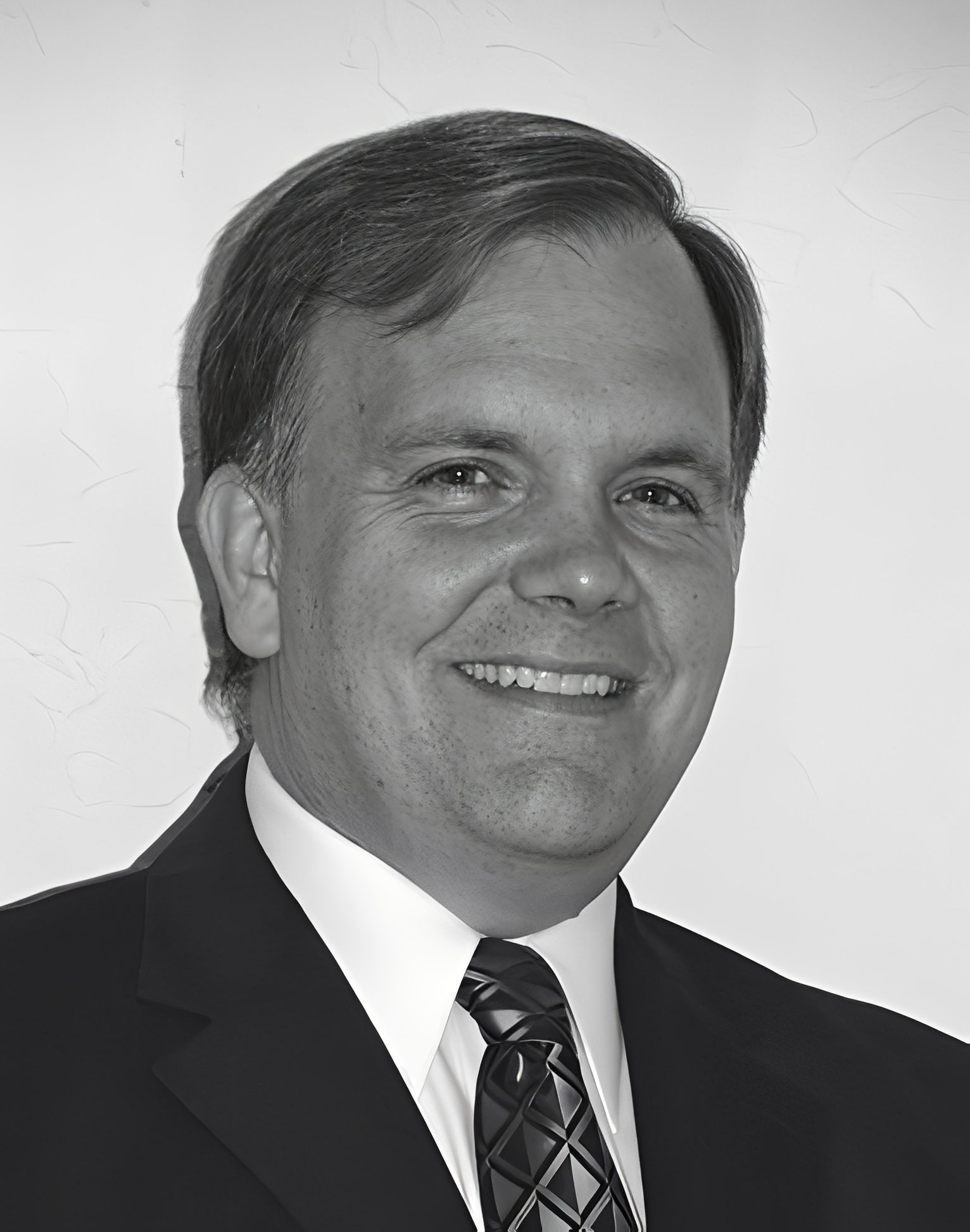 Smiling man in suit and patterned tie