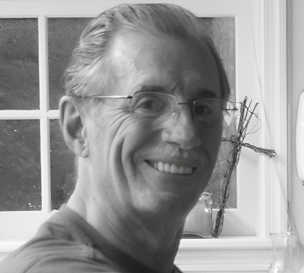 Smiling person wearing glasses by window