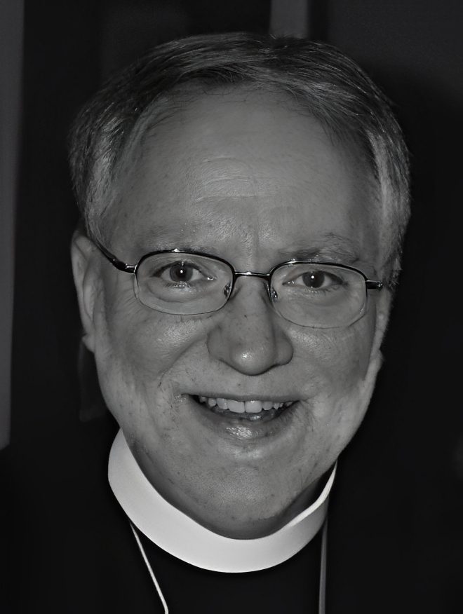 Smiling clergyman with glasses and collar