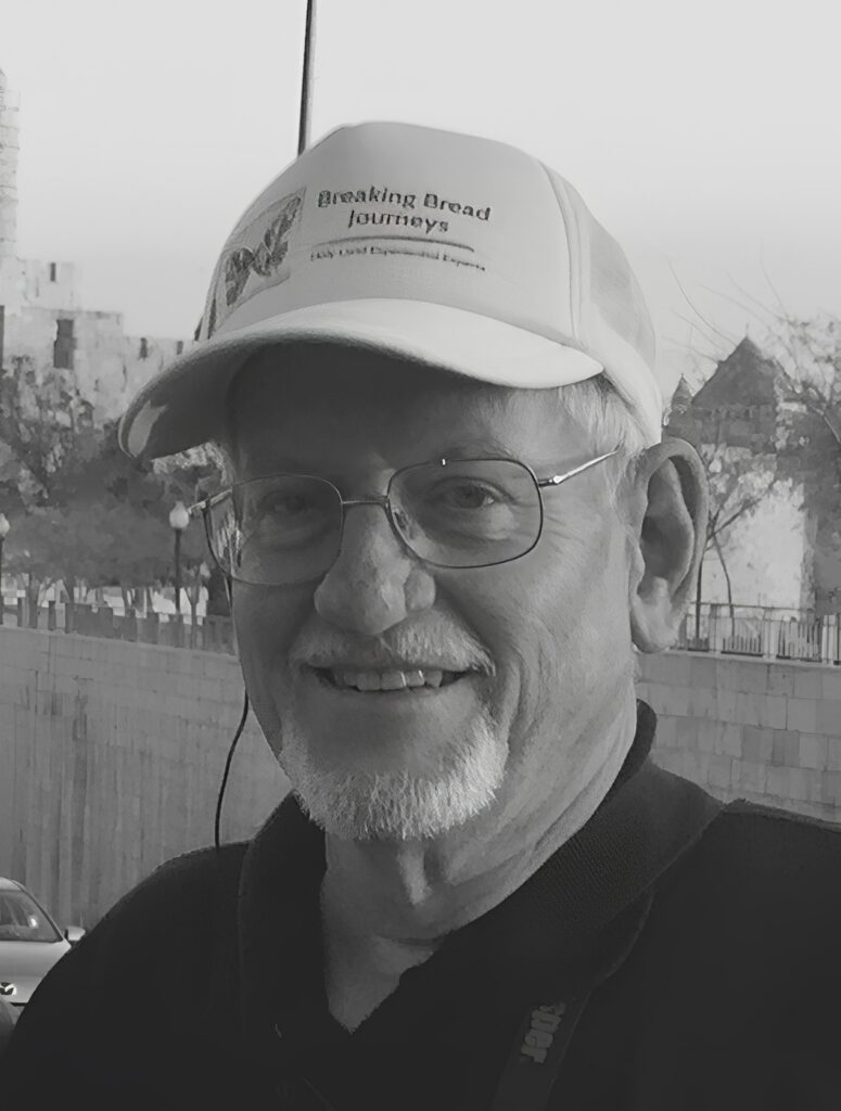 Smiling older man wearing cap and glasses