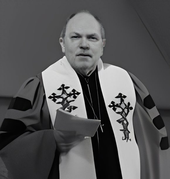 Clergyman in ceremonial robe holding papers