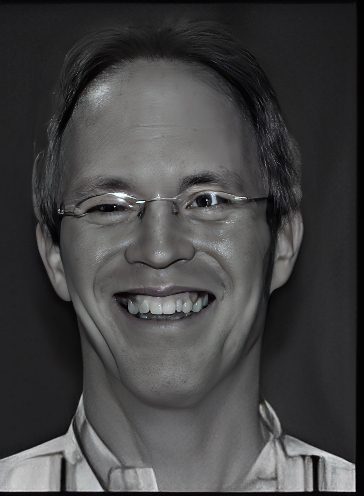 Smiling man wearing glasses, black-and-white portrait