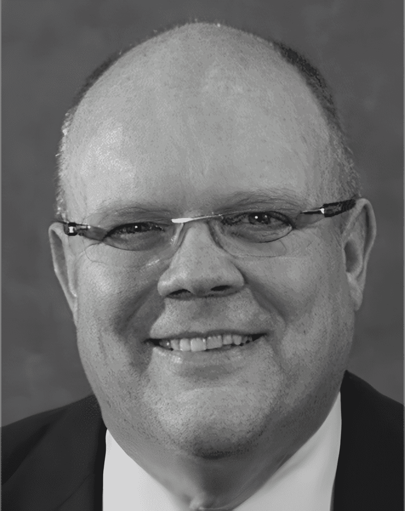 Smiling man with glasses in suit