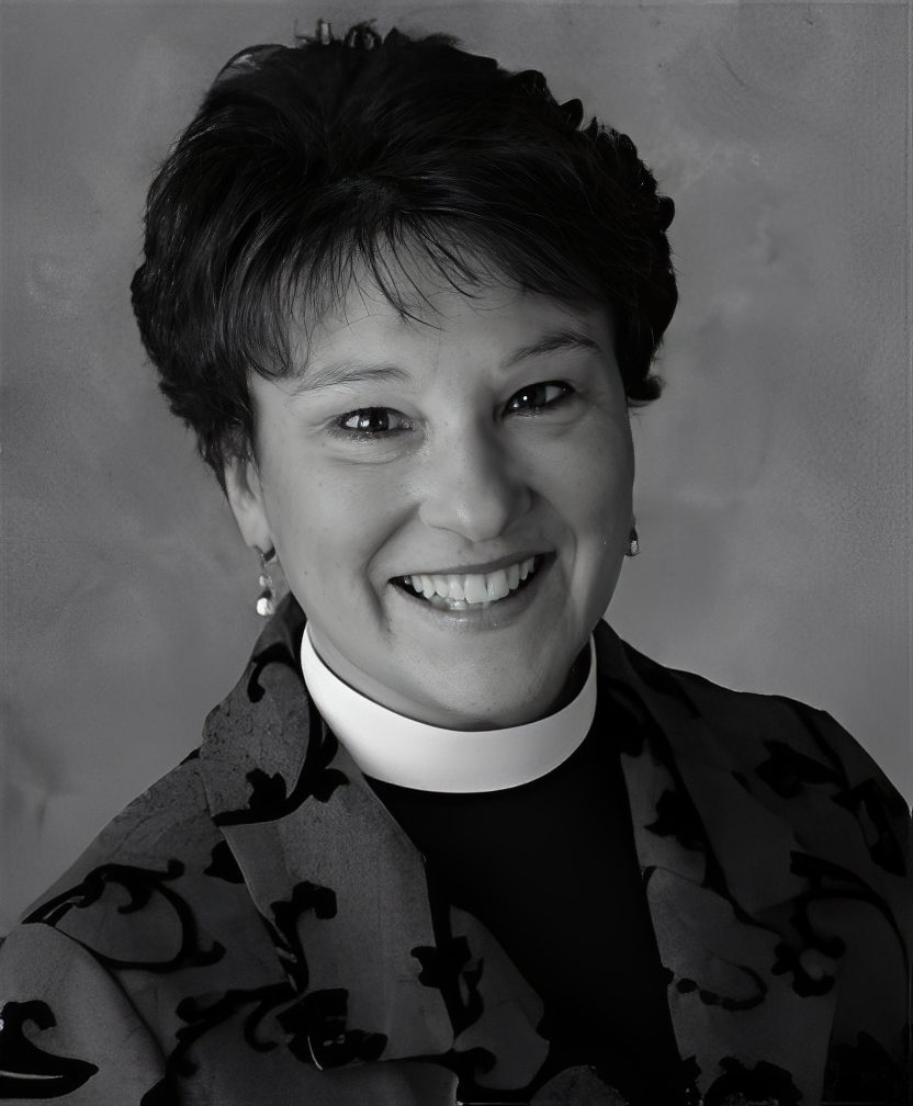 Smiling person with white collar and jacket