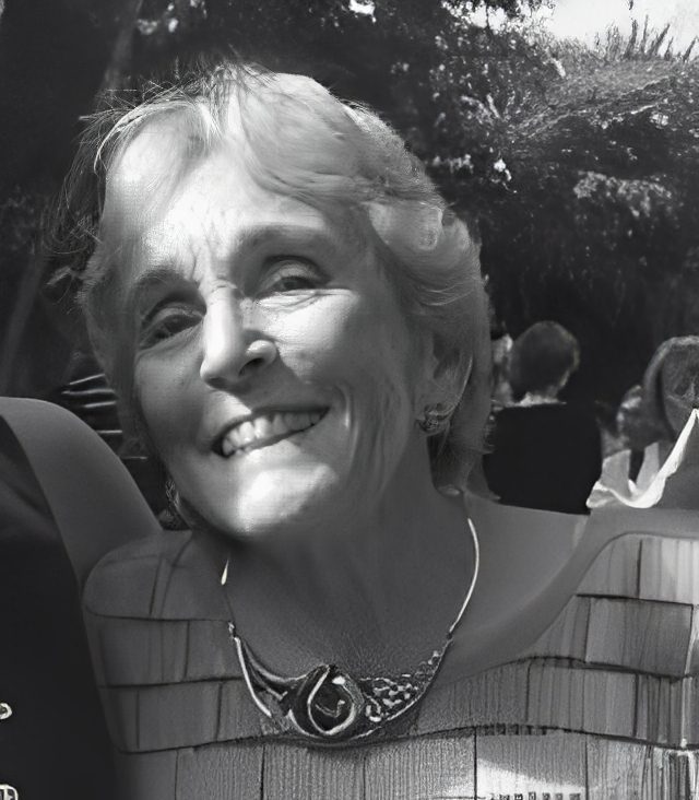 Black-and-white portrait of smiling elderly woman