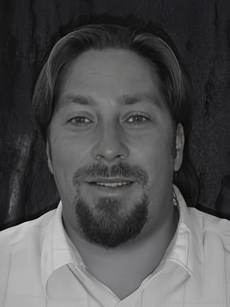 Smiling man with goatee in white shirt