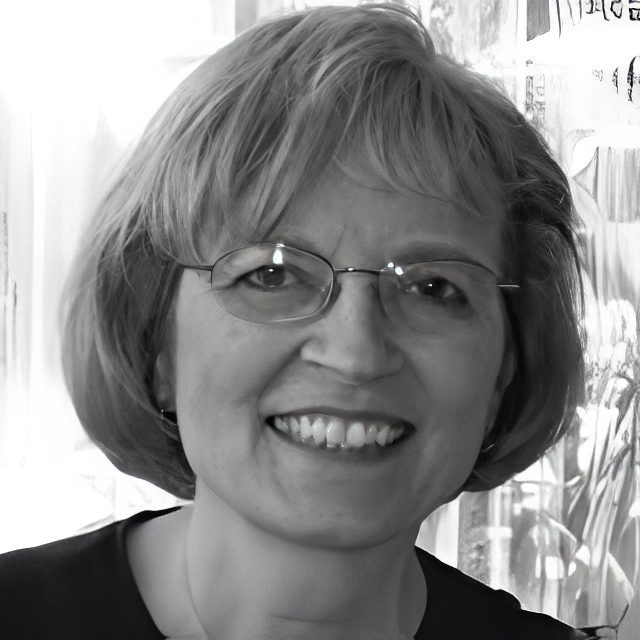 Smiling woman with glasses, short haircut