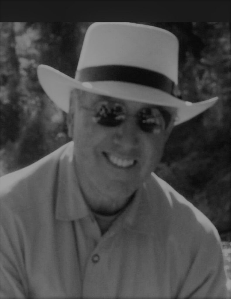 Smiling man in white hat and sunglasses