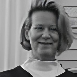 Smiling person in black-and-white portrait