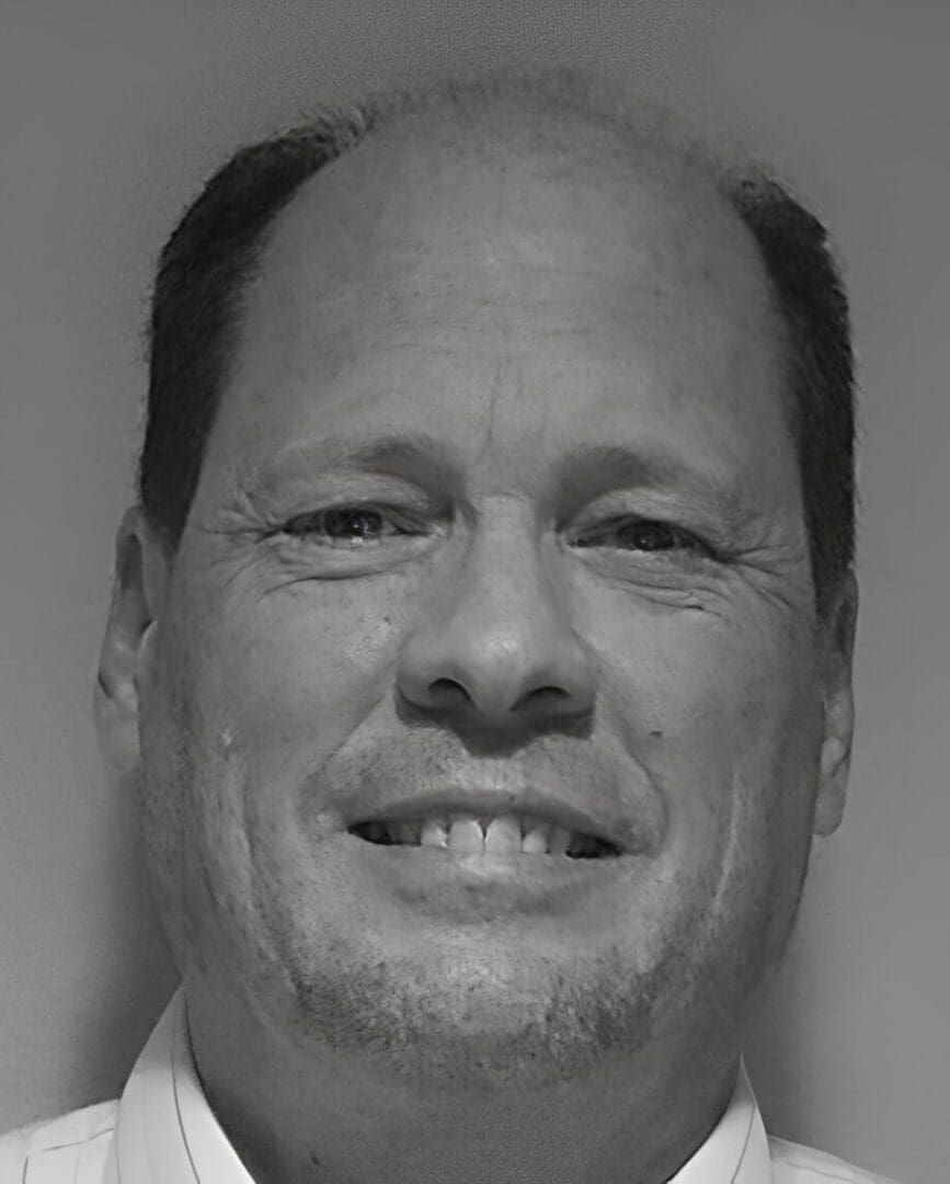 Black-and-white close-up of smiling man