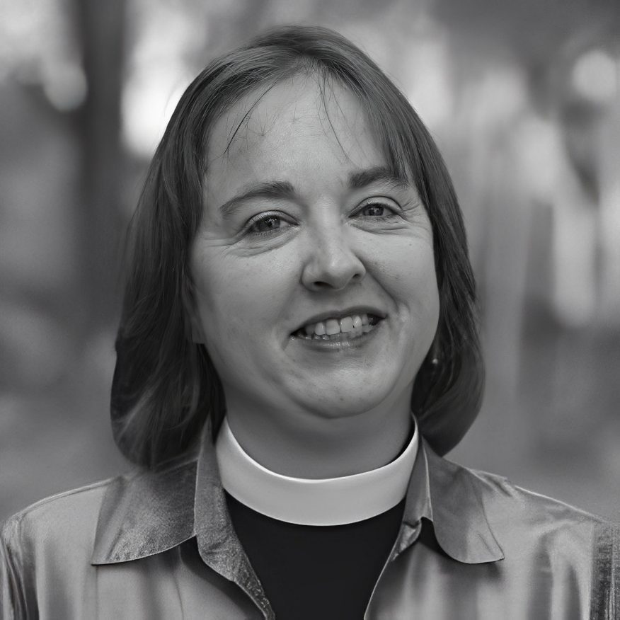 Smiling person wearing clerical collar