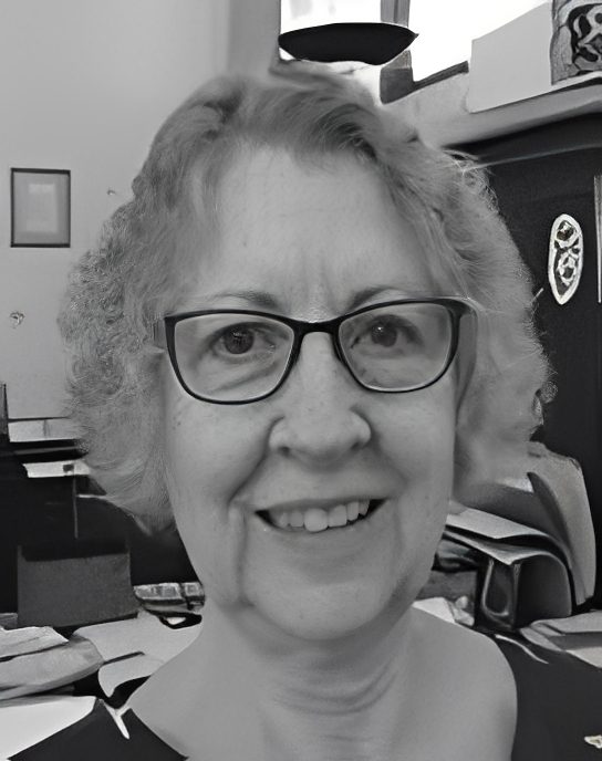 Smiling woman with glasses in office