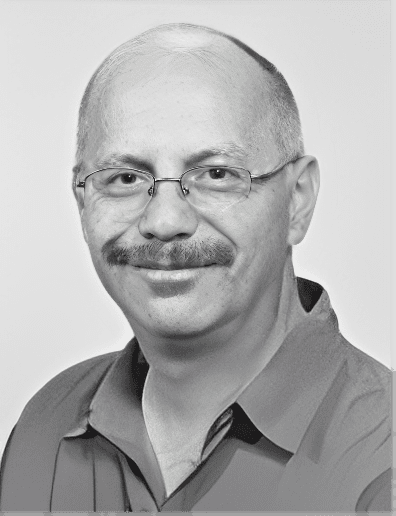 Smiling bald man with mustache and glasses