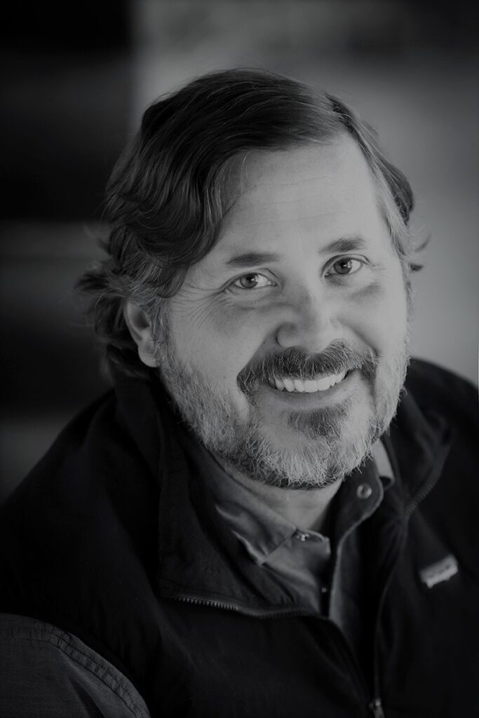 Smiling man in black-and-white portrait