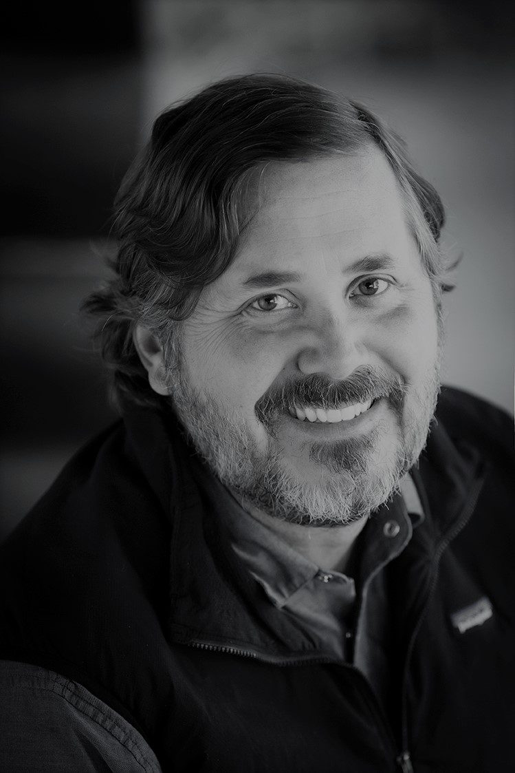 Smiling man in black-and-white portrait